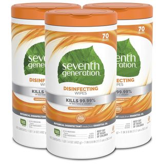 Three cylindrical packets of white and orange disinfecting wipes with a green leaf logo