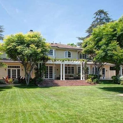 sloping roof house with swimming pool and trees