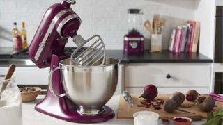 KitchenAid Artisan Series 5 Quart Tilt-Head Stand Mixer in Beetroot on a table with the K400 Blender in the background