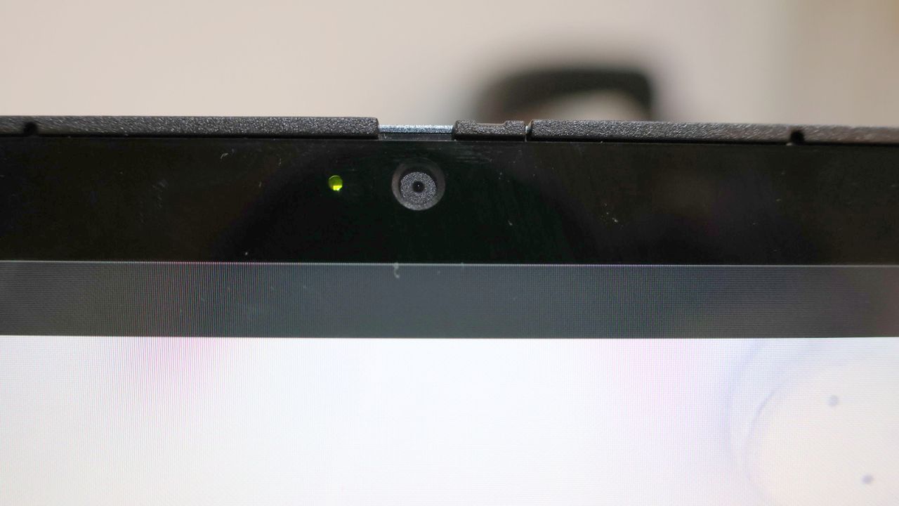 Close up of the Acer Chromebook Spin 714's webcam against a pink background.