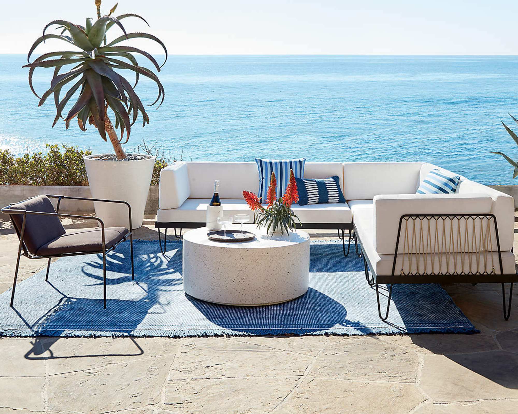 Contemporary outdoor furniture on a patio overlooking the ocean