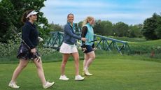 Female golfers walking on fairway