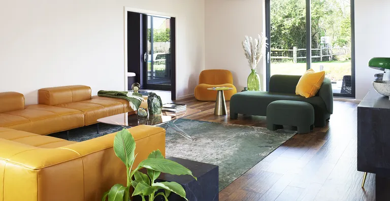 neutral living room with yellow and green seating