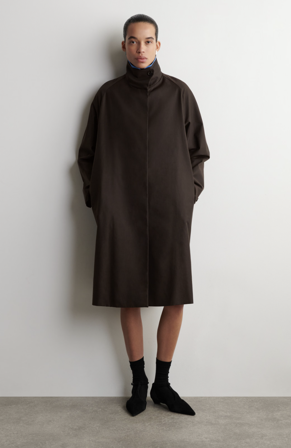 a model wearing a brown jacket