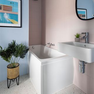 blue and pink painted bathroom with white bath and basin