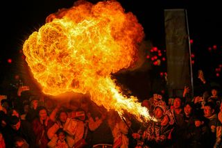 A fire breathing performer.