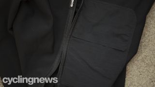 A close up of the self-storage pocket built into the Assos Equipe RS Mid Layer