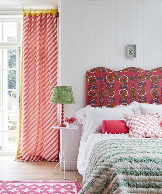 country decorating ideas - pretty patterned bedroom with wavy upholstered headboard and stripe curtains