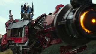 Optimus Prime wields his iconic gun in Transformers: Rise of the Beasts, the seventh entry in our Transformers movies in order guide