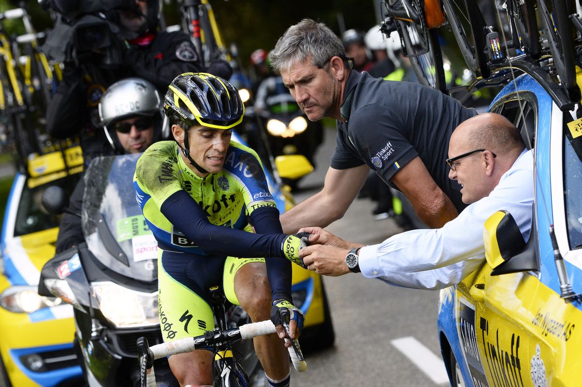 Team boss Bjarne Riis helps Alberto Contador after his crash at the 2014 Tour