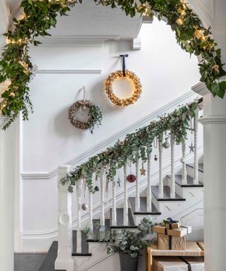 Wreaths with string lights, bulbuls from banister