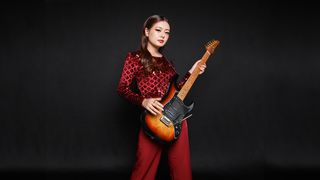 Imnainla Jamir with an Ibanez guitar