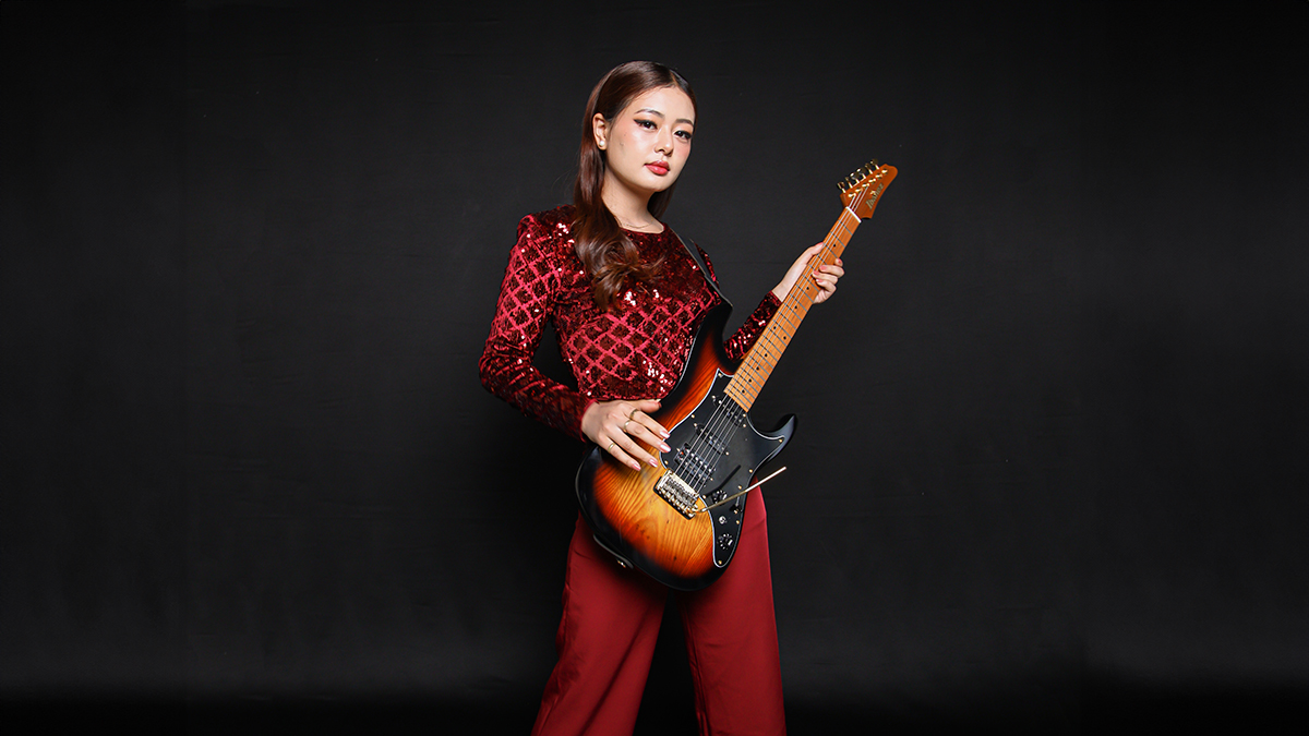 Imnainla Jamir with an Ibanez guitar