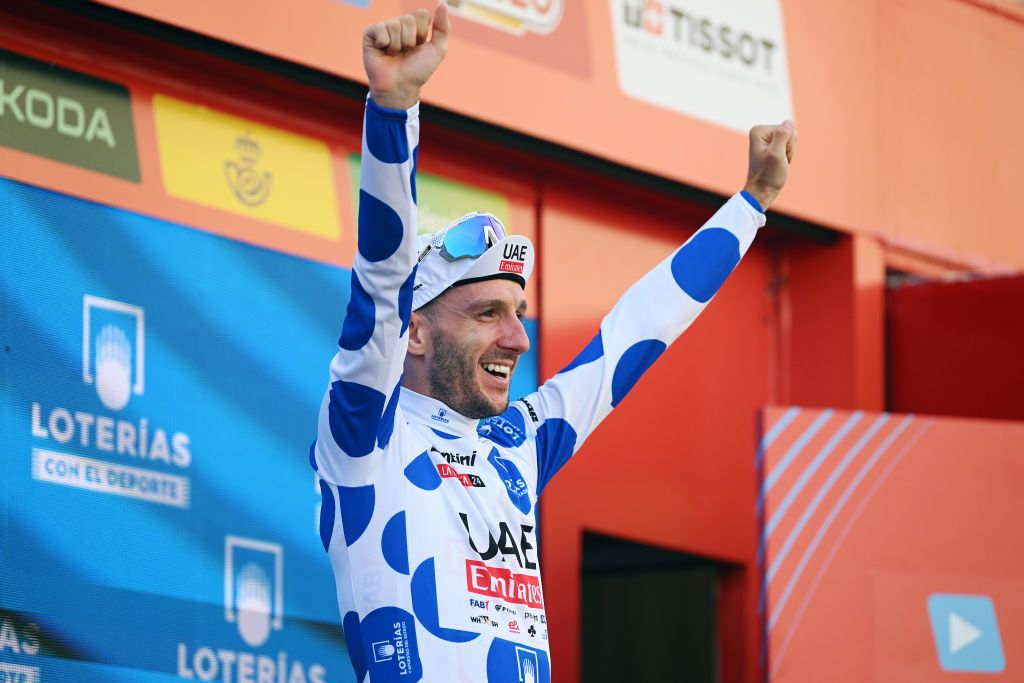 GRANADA SPAIN AUGUST 25 Adam Yates of The United Kingdom and UAE Team Emirates celebrates at podium as Polka dot Mountain Jersey winner during the La Vuelta 79th Tour of Spain 2024 Stage 9 a 1785km stage from Motril to Granada UCIWT on August 25 2024 in Granada Spain Photo by Dario BelingheriGetty Images