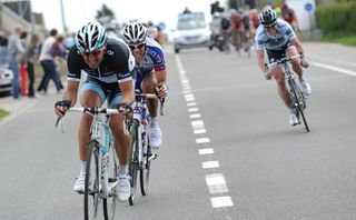 Nick Nuyens (behind) goes across to Fabian Cancellara and Sylvain Chavanel