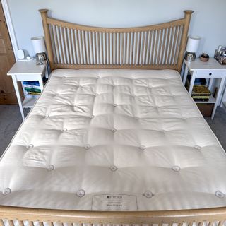 The Hypnos Wool Origins 6 mattress being tested in a bedroom with a wooden bedframe