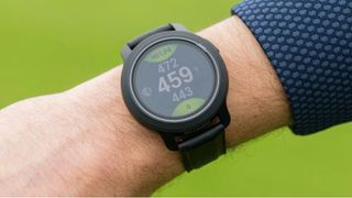 The fantastic looking GolfBuddy Aim W12 Golf GPS Watch as worn on the course, showing off its vibrant and large touch screen