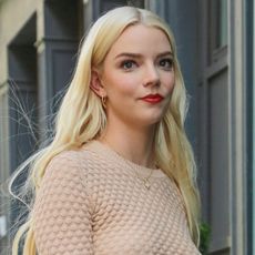 Anya Taylor-Joy wears a tan long-sleeve top