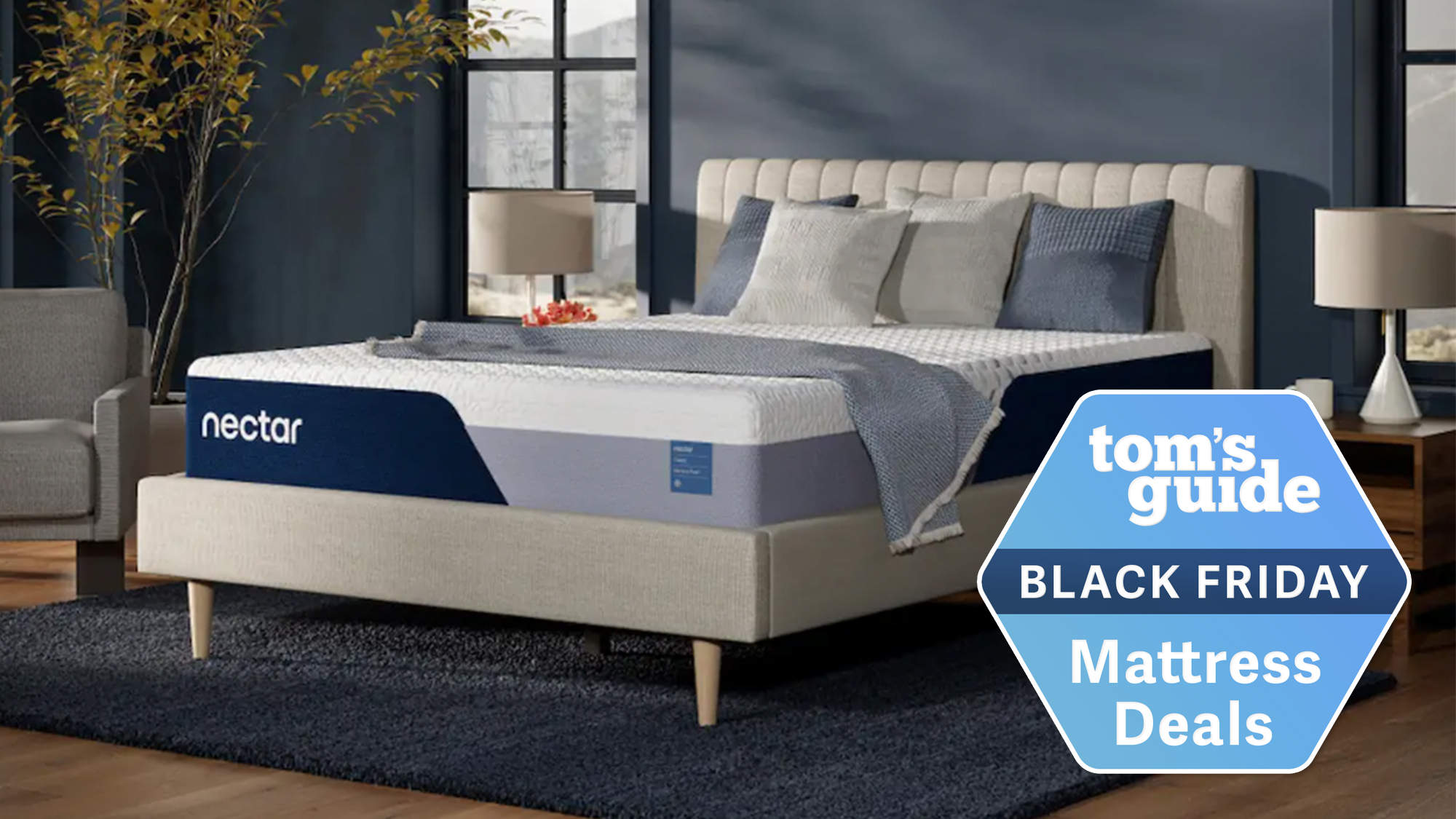 A Nectar Classic mattress on a cream bedframe in a blue bedroom with Tom's Guide Black Friday label