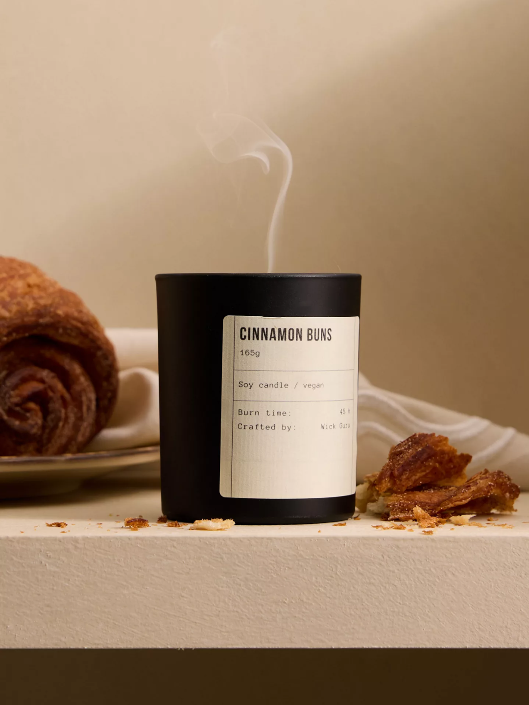 A black cinnamon buns scented candle from Wick Guru