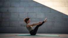 A woman practicing wall Pilates