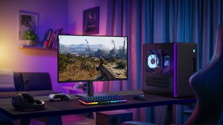 Alienware AW2726DM gaming monitor in a room, next to an Alienware gaming PC