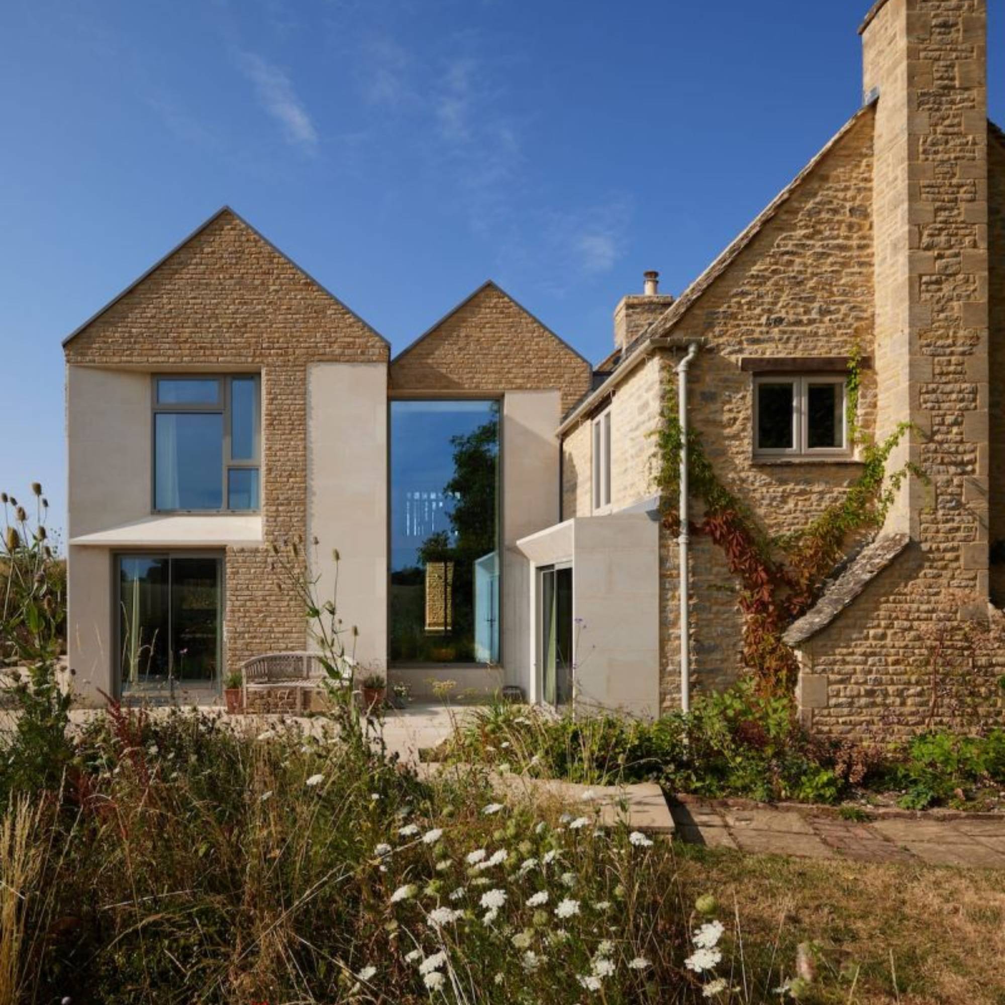 render and stone cladding on modern extension to traditional cottage