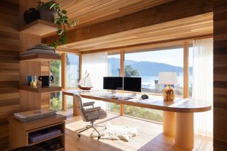 a home office with views out over a lake