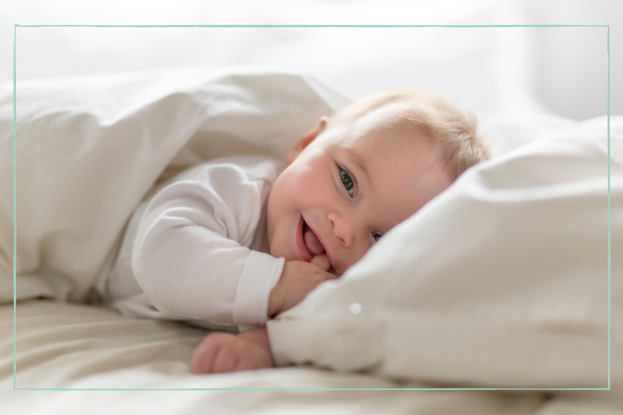 baby smiling in bed