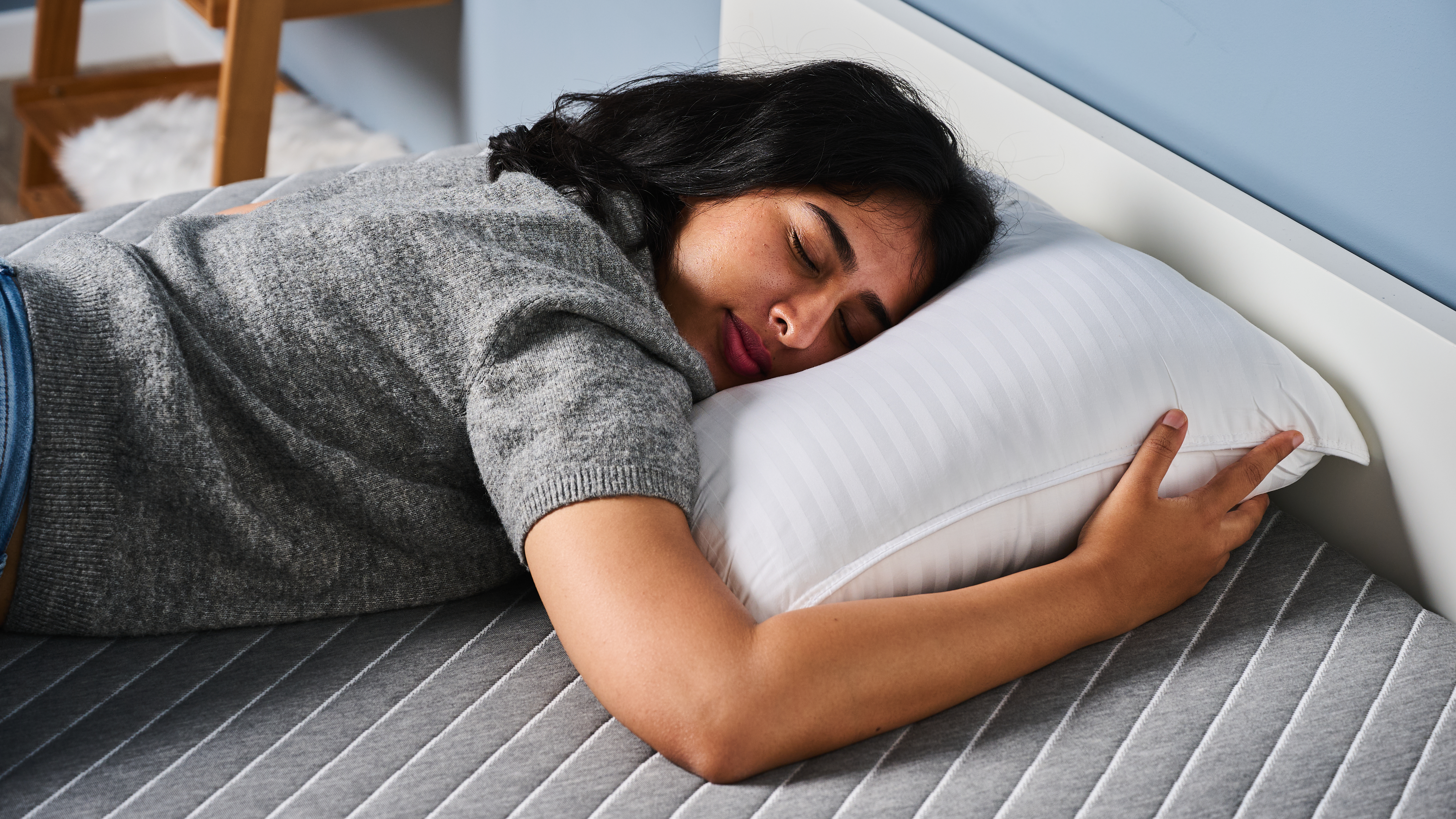 TG bedding writer testing the Beckham Hotel Collection Down-Alternative pillow by lying on it in our TG Sleep Studio