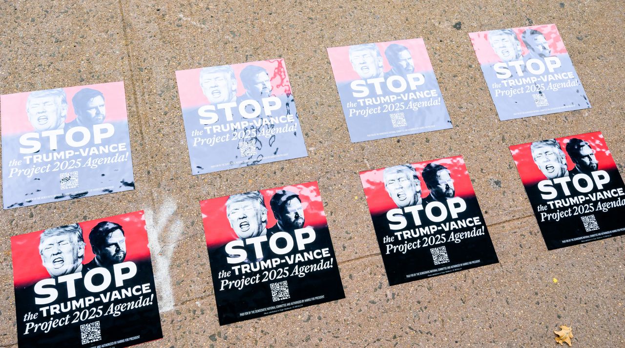 signs showing Project 2025 posters on the ground