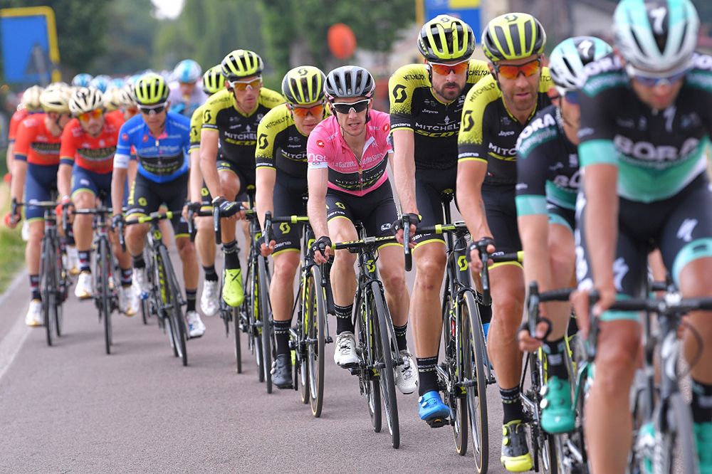 Simon Yates (Mitchelton-Scott) wears the pink leader's jersey and sits in the field during stage 13 at the Giro d'Italia