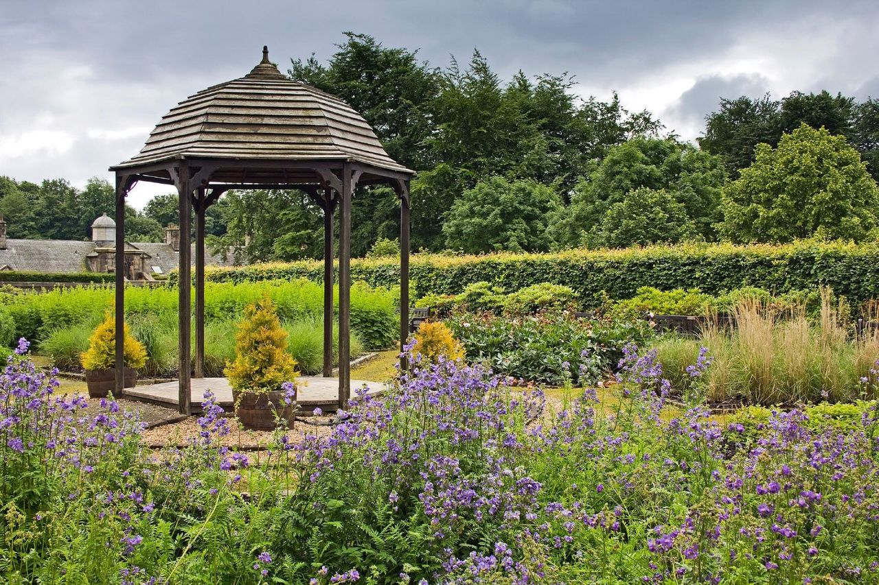 Garden Folly Surrounded By Plants And Flowers