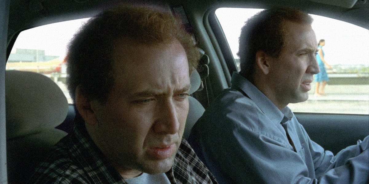 Charlie Kaufman (Nicolas Cage) drives a car with his twin brother Donald Kaufman (Nicolas Cage) sitting in the passenger seat in &#039;Adaptation&#039;