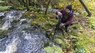Dan Mold using a Giottos Tripod to photograph a mountain stream