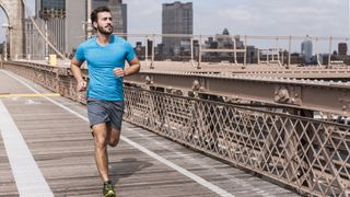 Fit young man running on bridge