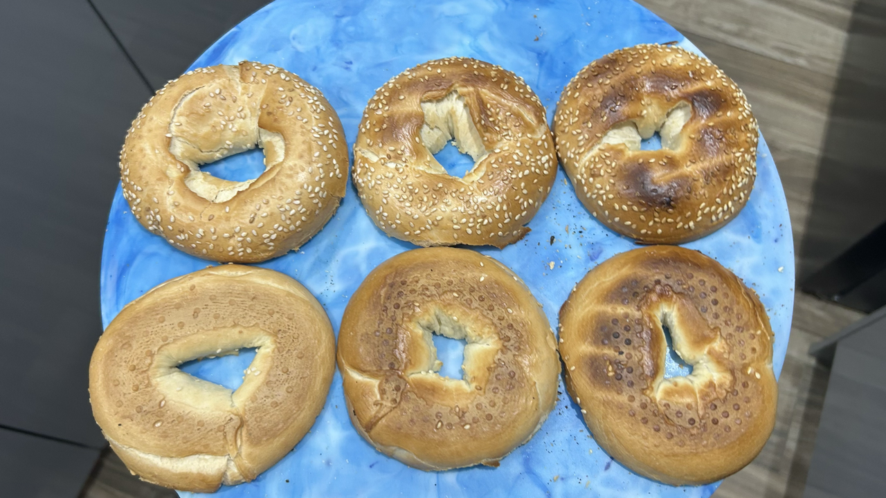 Toasted bagels on blue board