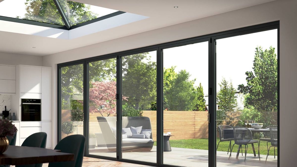 3D of a kitchen extension with a wide set of bifold doors looking out over a modern patio, together with a roof lantern above bringing in natural light