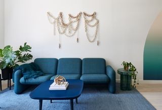 a blue sofa living room with a green side table