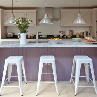 kitchen with white stool hanging light and worktop