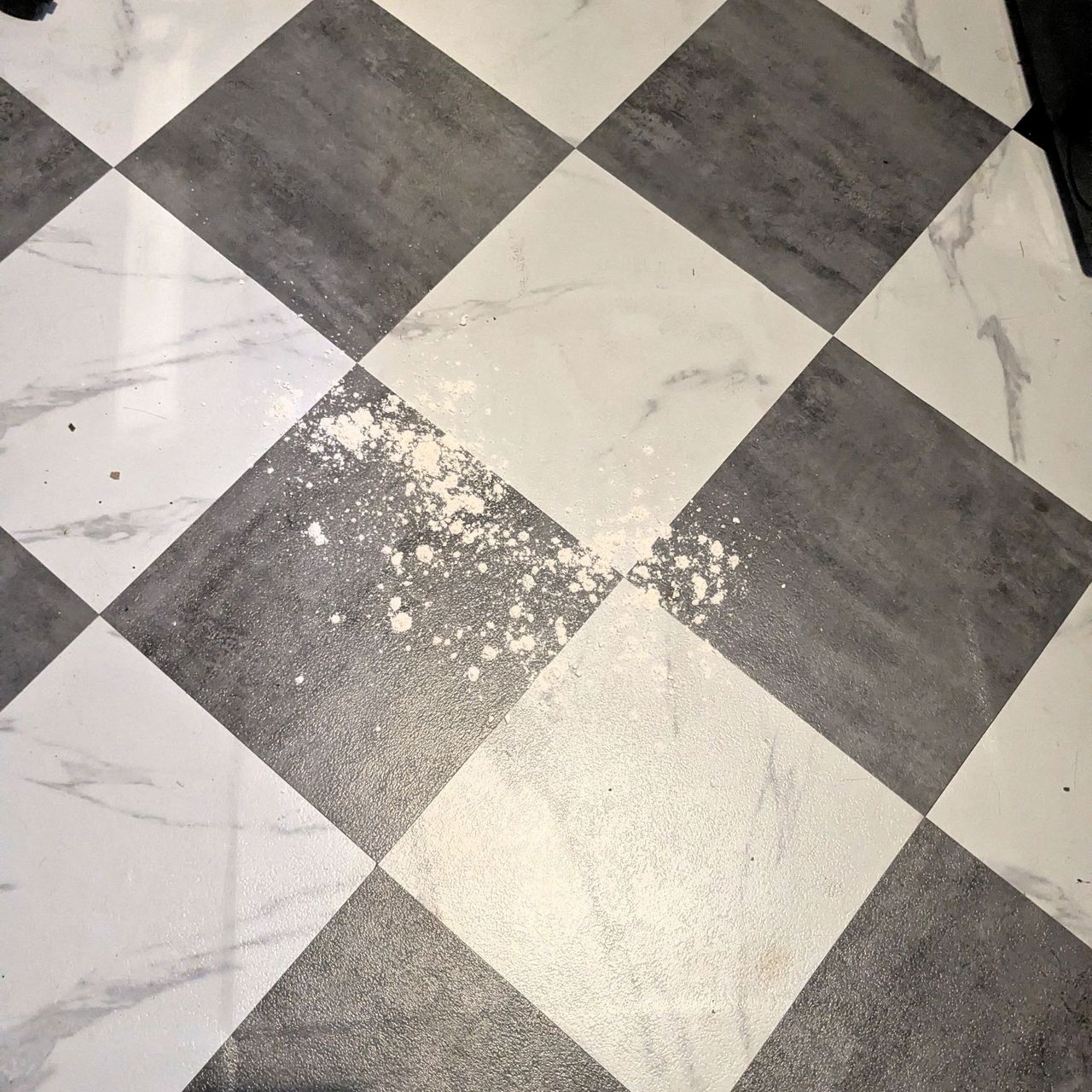 Flour on white and black checkerboard flooring