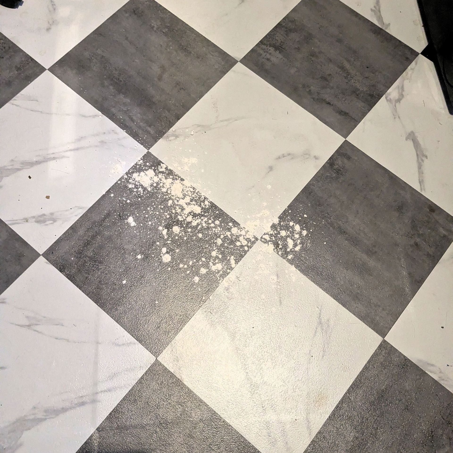 Flour on white and black checkerboard flooring