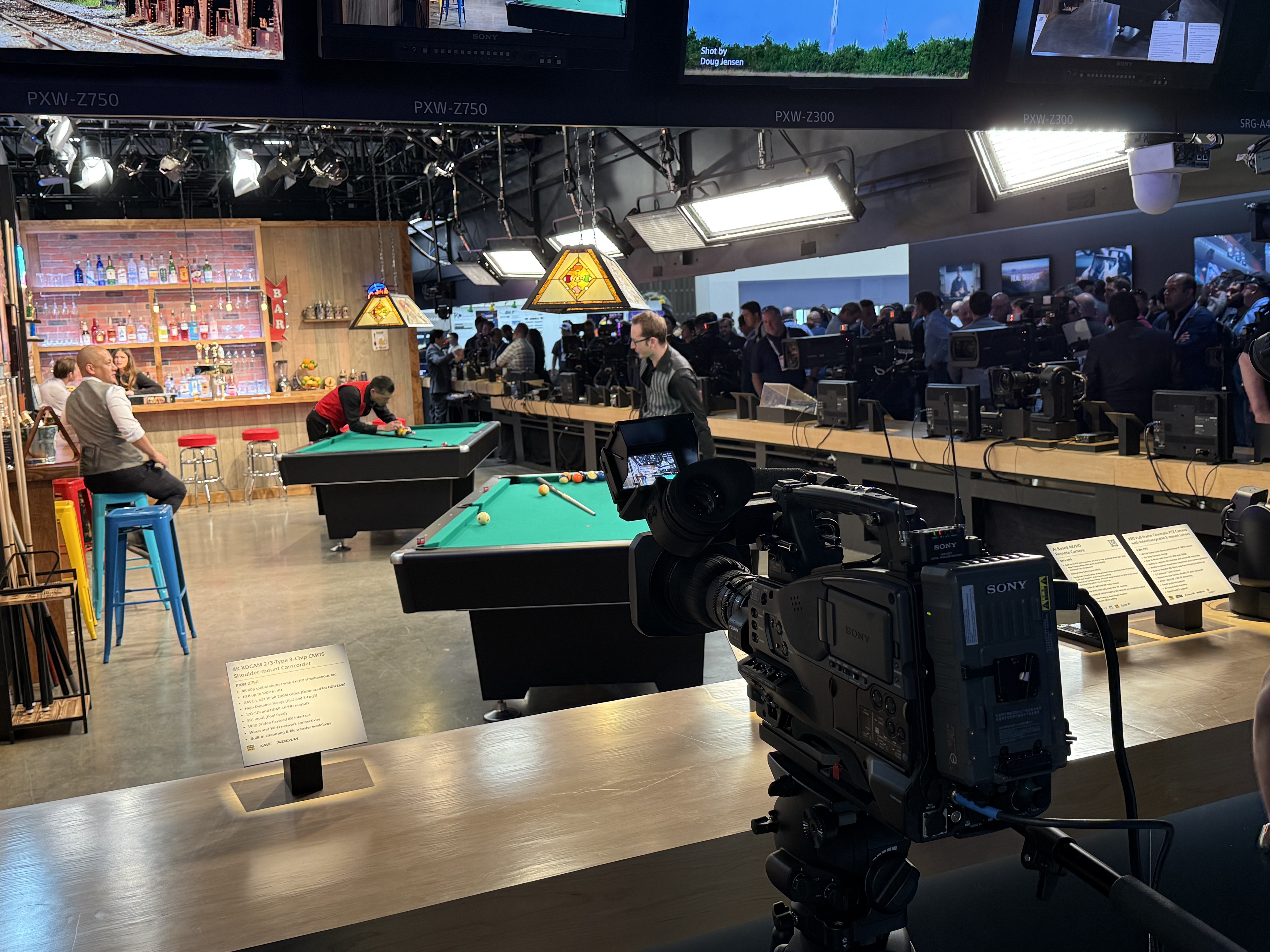 Views from the NAB Show 2026 show floor including wrestlers, Shure audio, a mock production set, and Roger and James Deakins.