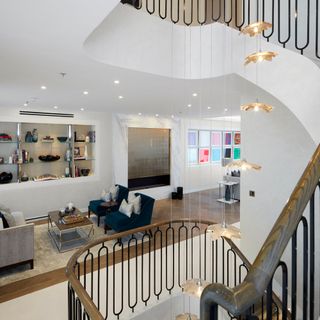 living area with staircase wooden handrail chandelier and bespoke parquet flooring