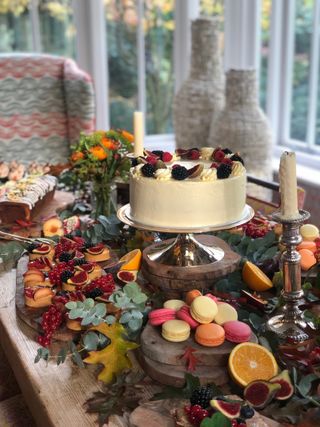 Christmas dining table with cake stand and fruits by Kit Kemp