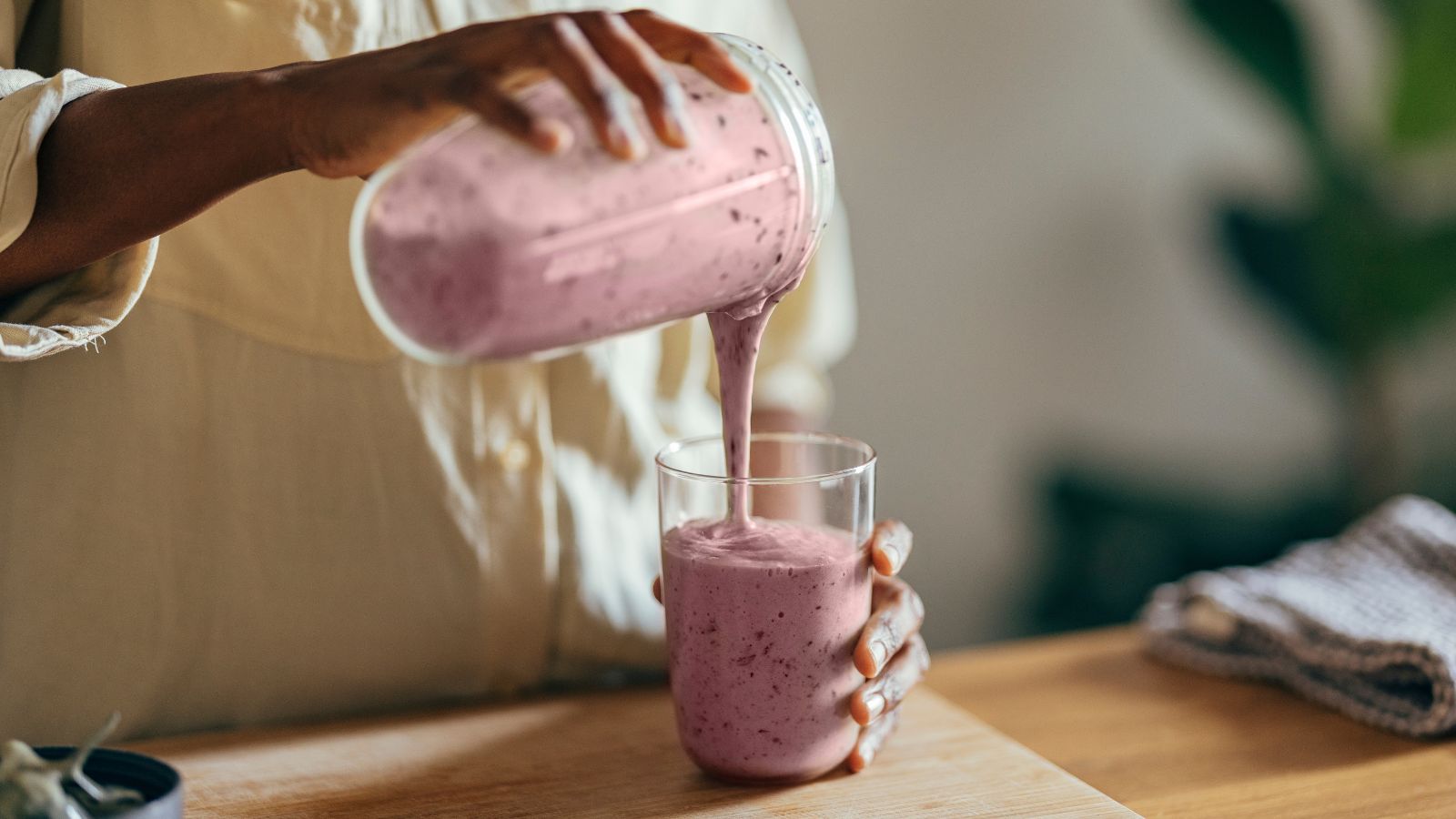 Pink berry smoothie poured into a glass