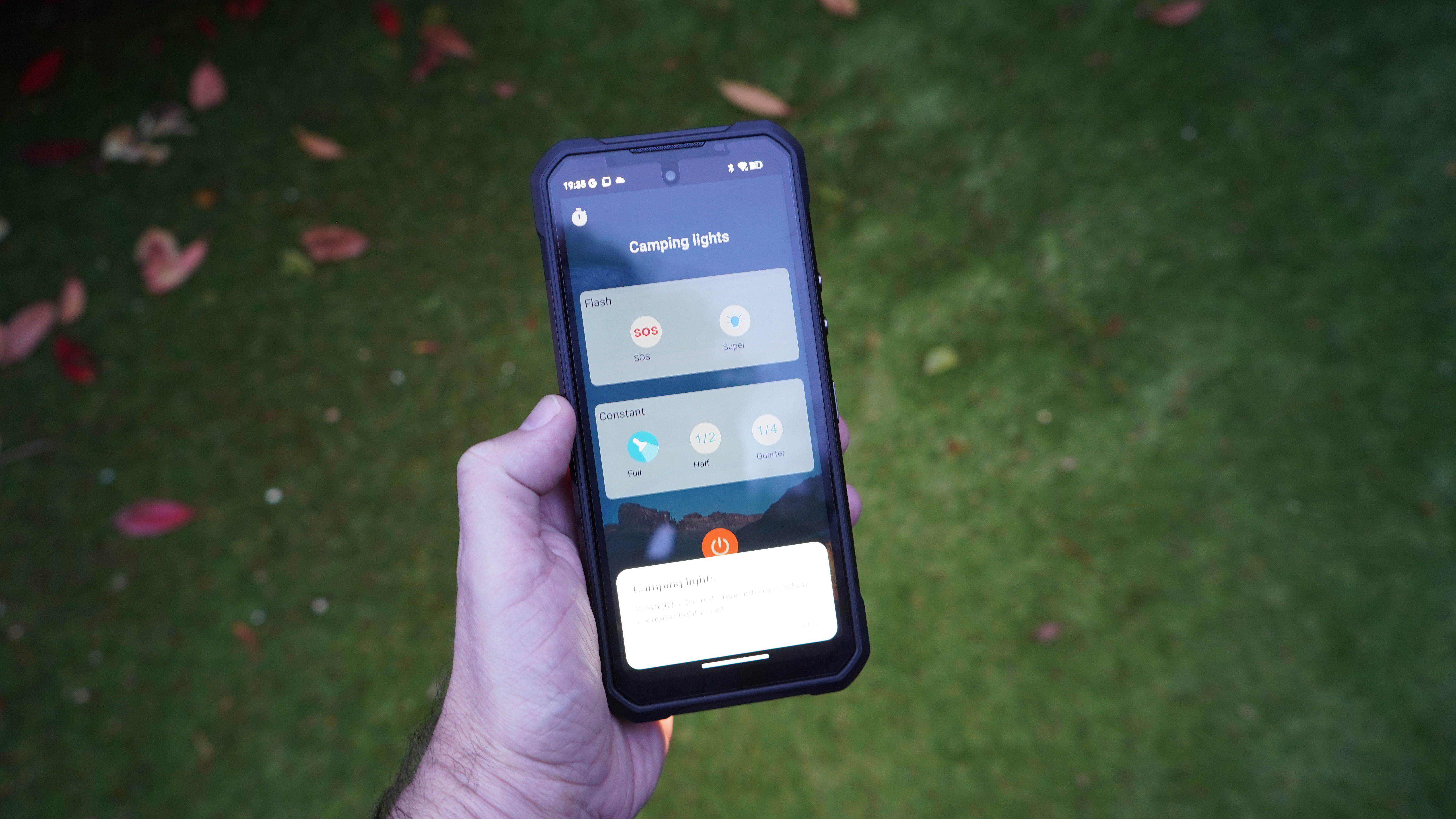 Oukitel WP61 Ultra phone in the hand, showing the camping light menu