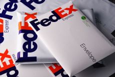 FedEx envelopes stacked messily on top of one another