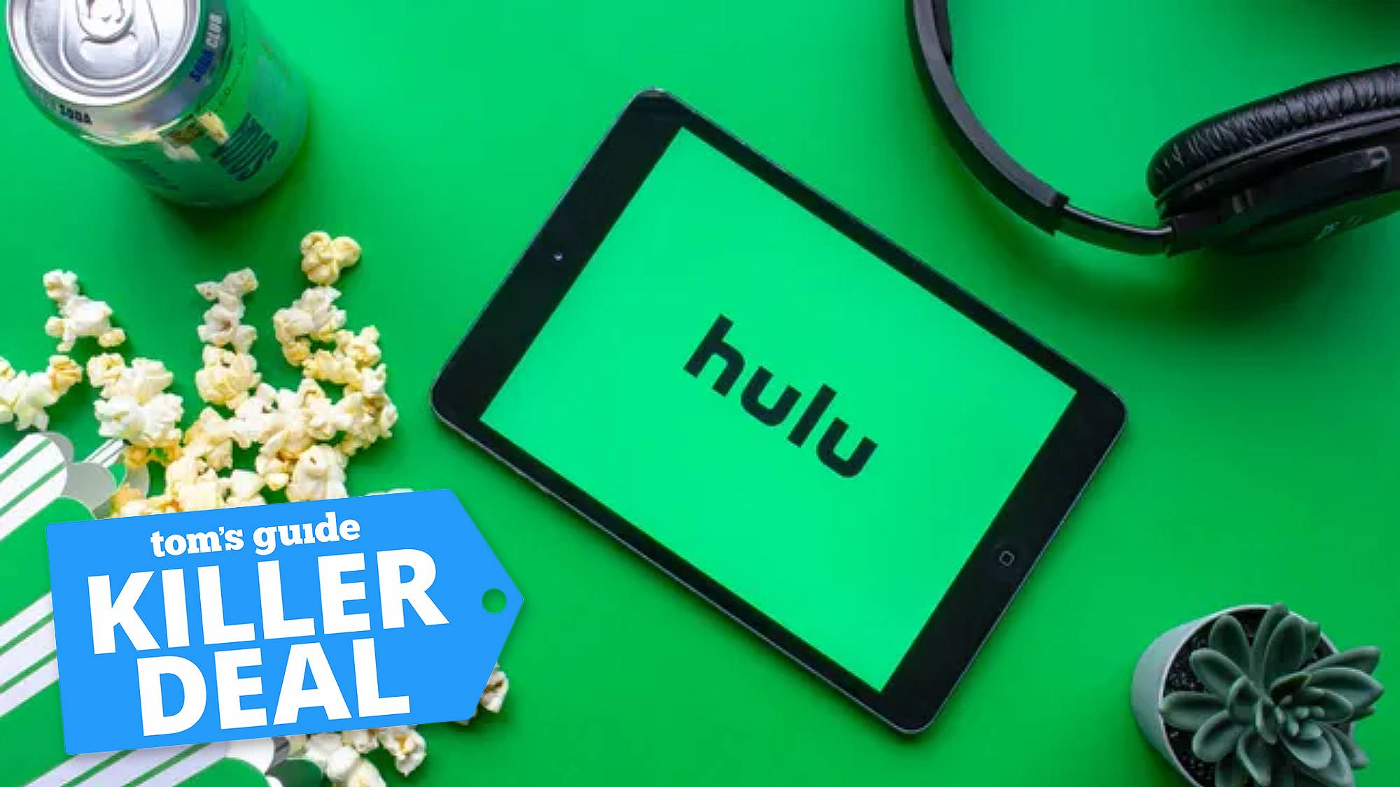 A tablet with the Hulu logo surrounded by popcorn, soda, headphones and a cactus