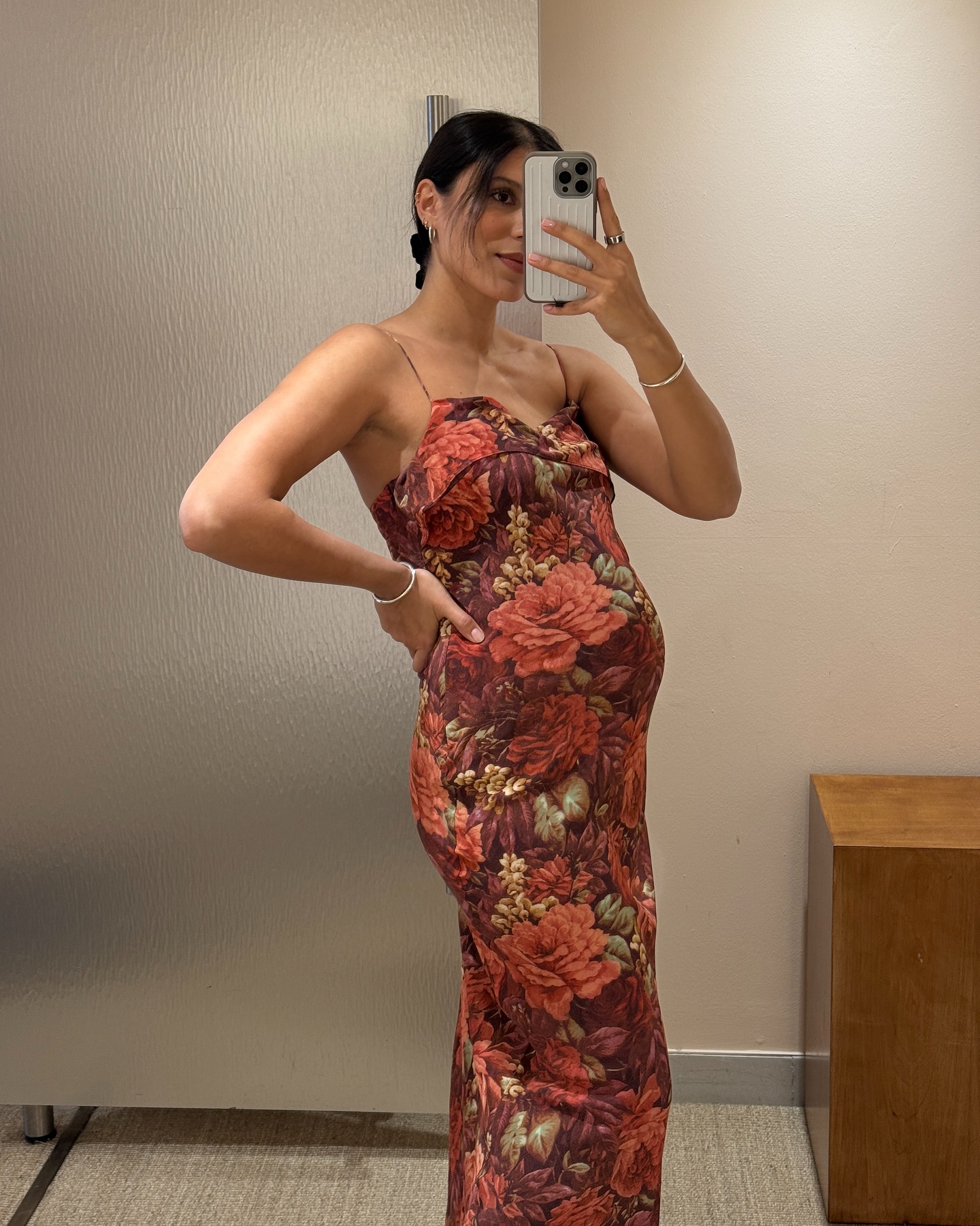 An image of @theindiaedit wearing a red floral wedding guest dress from Faithfull the Label.